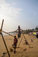 ANJUNA, INDIA, OCTOBER 14, 2015 - Unidentified Goan Girl on a tightrope at the Anjuna Beach. photo
