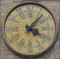 Ancient watch on the wall in PArma, Italy photo