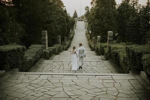 Young newlywed couple walking in the park photo