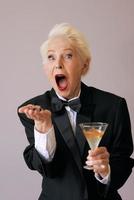stylish mature senior woman in tuxedo celebrating new year. Fun, party, party is over, style, celebration concept photo