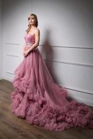 portrait of young beautiful woman in long pink dress photo