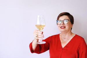 stylish mature senior woman with glass of wine. Fun, party, style, lifestyle, work, alcohol, celebration concept photo