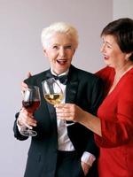 Two beautiful stylish mature senior women drinking wine. Fun, party, style, celebration concept