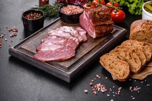 Delicious fresh bacon sliced with bread and vegetables photo