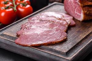 Delicious fresh bacon sliced with bread and vegetables photo