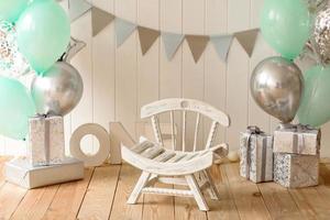 Beautiful interior with white and blue tones, with a chair and letters for one year photo