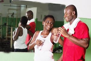 Young woman and her coach in a gym. photo