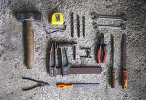 Carpenter tools on concrete background photo