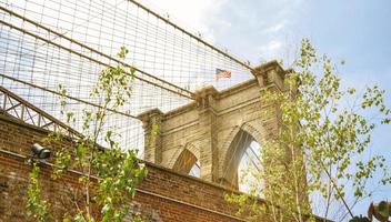 Towers and American flag over Brooklyn Bridge photo