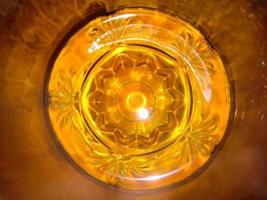 Closeup glass with yellow water photo