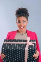 Happy and cheerful afro american woman with present box photo