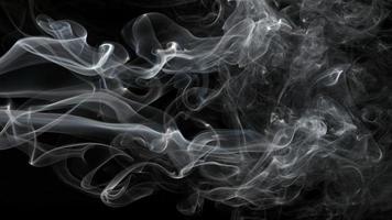 Smoke isolated on black background. Movement of white smoke photo