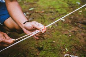 hand force catch the lock. force rope. tent rope buckle photo