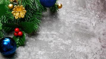 Christmas pine tree leaves and christmas decorations on grunge background. Creative christmas concept. photo
