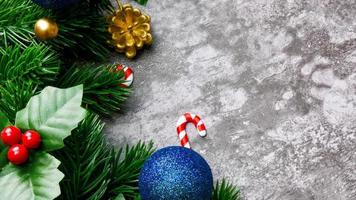 Christmas pine tree leaves and christmas decorations on grunge background. Creative christmas concept. photo