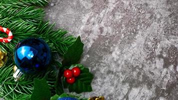 Christmas pine tree leaves and christmas decorations on grunge background. Creative christmas concept. photo