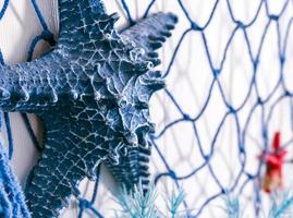 Blue net and artificial starfish made of plastic on the wall decoration photo