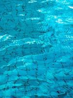 Reflection of sky on the moving water surface in the pool photo