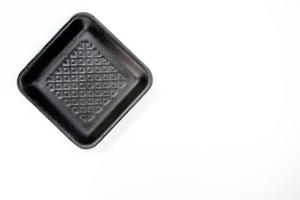 Black foam tray isolated in white background photo