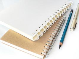 The spiral notebook with pencil and pen photo