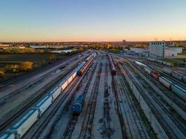 aerial view of train marshaling yard with autumn scenery in background photo