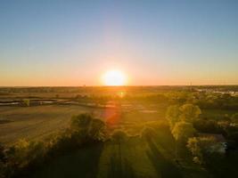 sunset in autumn over farm field with amazing colors photo