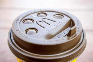 Plastic brown or black disposable top coffee lid with McDonald's fast food restaurant logo close up. Disposable coffee cup. Takeaway beverage cup. Ukraine, Kiev - September 13, 2021. photo