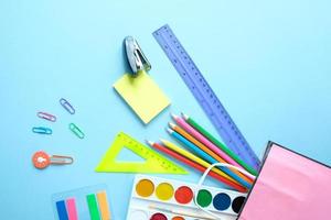 Back to school. The various stationery on light blue background. photo