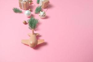 wooden children's plane on a pink background photo