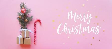Christmas holidays composition on pink background with lettering Merry Christmas photo