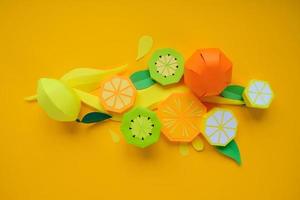 exotic fruits made of paper on yellow background photo