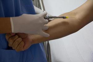 Close-up of a doctor's hands giving an injection. photo