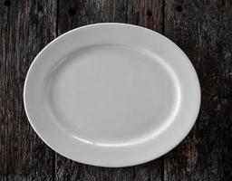 empty white plate on wooden photo