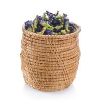 Dried pea flower in basket on white background photo