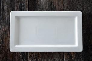 empty white plate on wooden photo