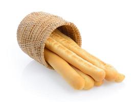 bread sticks in basket isolated on white background photo