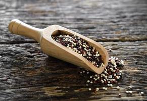 Quinoa seeds in scoop on wood photo