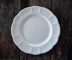 empty white plate on wooden photo