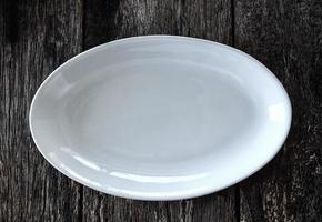 empty white plate on wooden photo