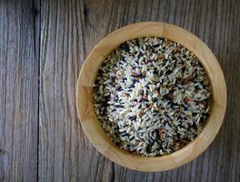 Brown rice seed in bowl. Top view. photo