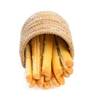 bread sticks in basket isolated on white background photo