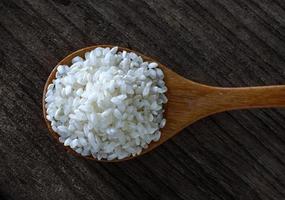 rice in spoon on wooden photo