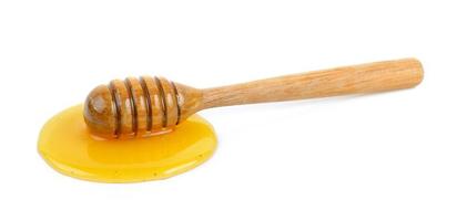 Wooden honey dipper with honey photo