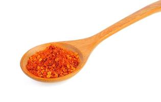 Cayenne pepper in wood spoon on white background photo