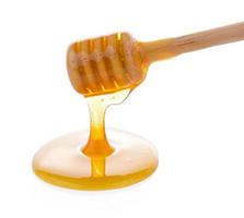 Wooden honey dipper with honey photo