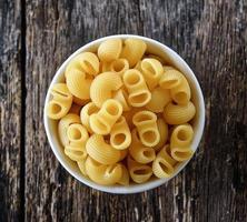 macaroni in bowl on wood photo