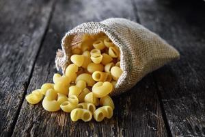 macaroni In the sack on wood table photo