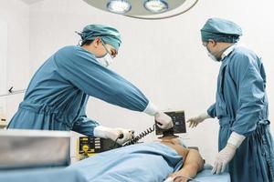 surgeon and assistant making CPR on the patient in the operating room. First Aid Emergency- Cardiopulmonary resuscitation photo