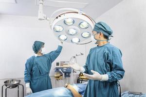 assistant surgeon preparing surgical lamps in the operating room photo