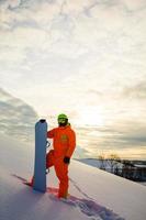 Snowboarder at the background of sunset photo